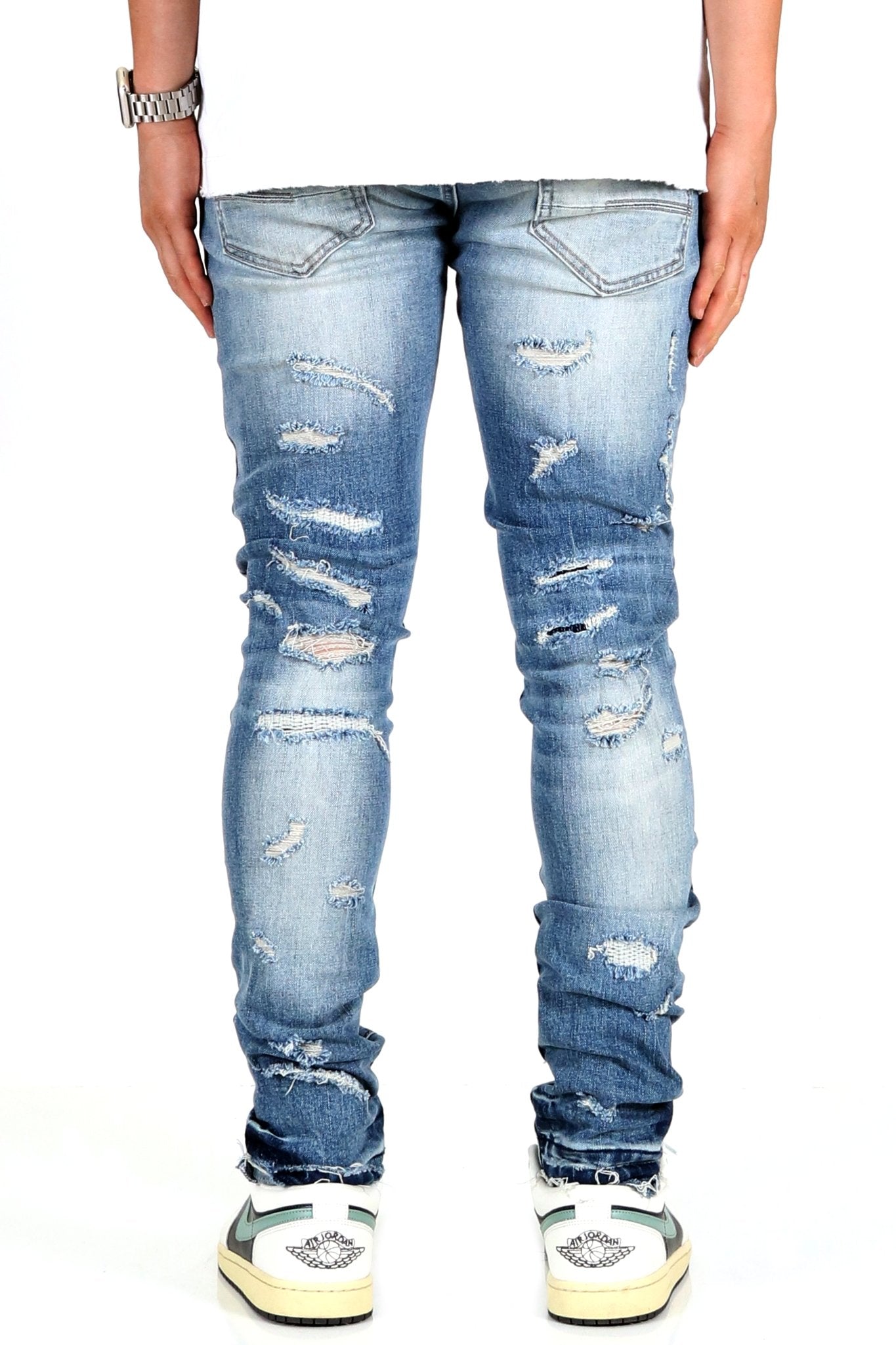 Back view of the blue distressed skinny jeans featuring ripped details.