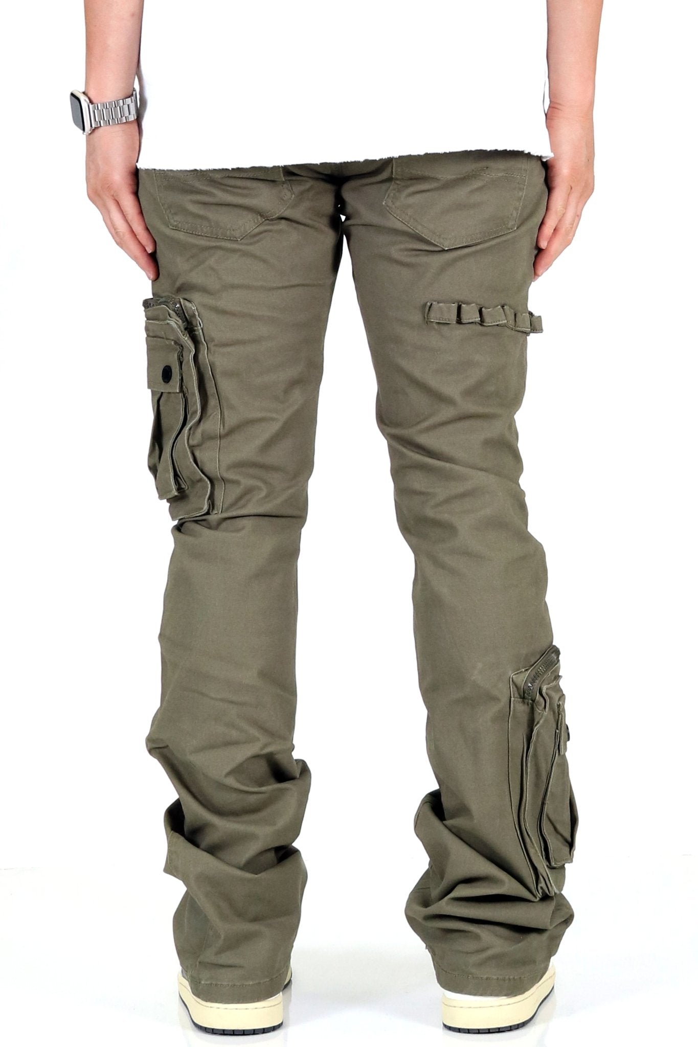 Back view of olive cargo pants highlighting multiple pockets and loose fit.