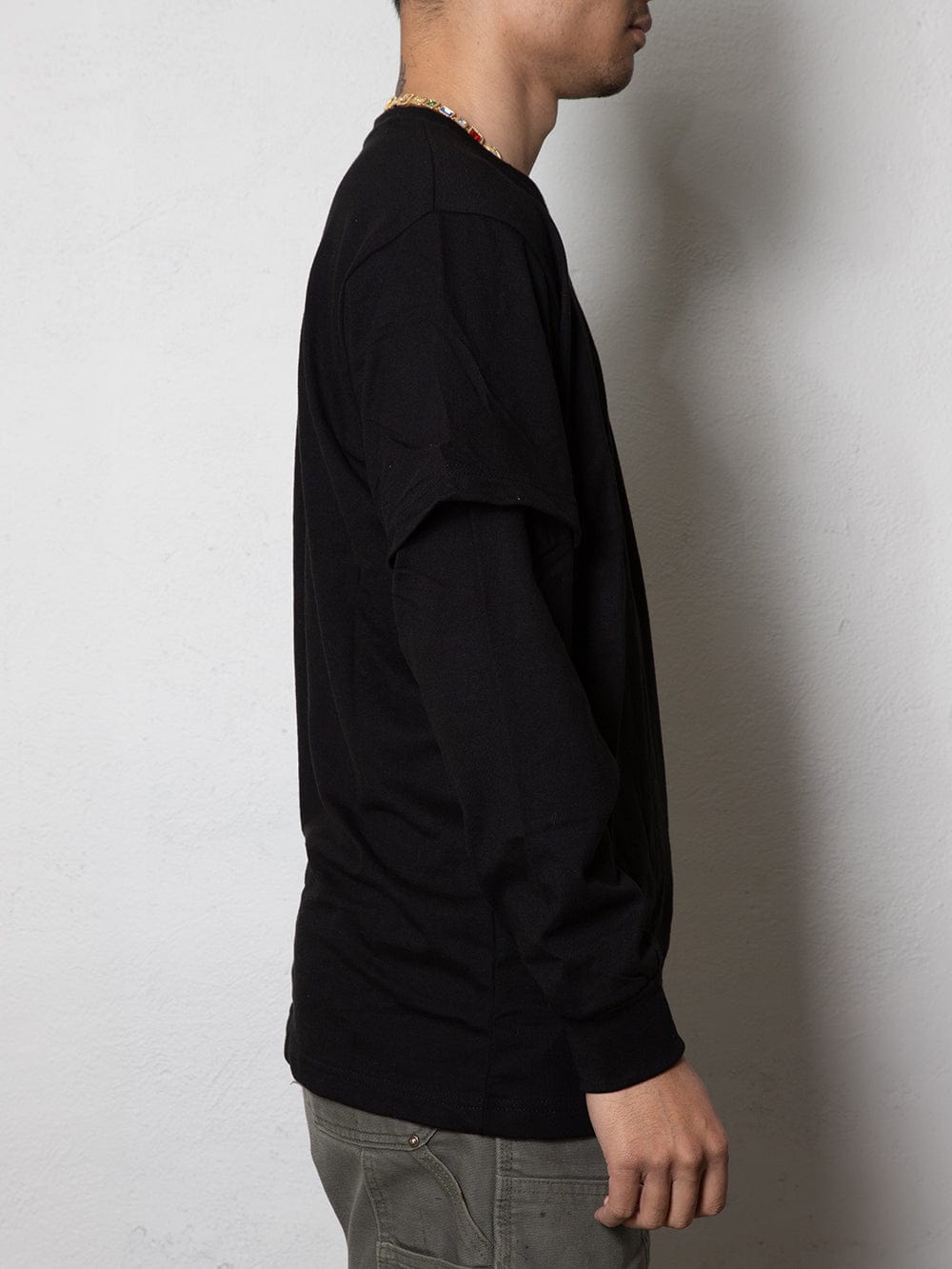 Side view of the black long sleeve t-shirt with a simple design.