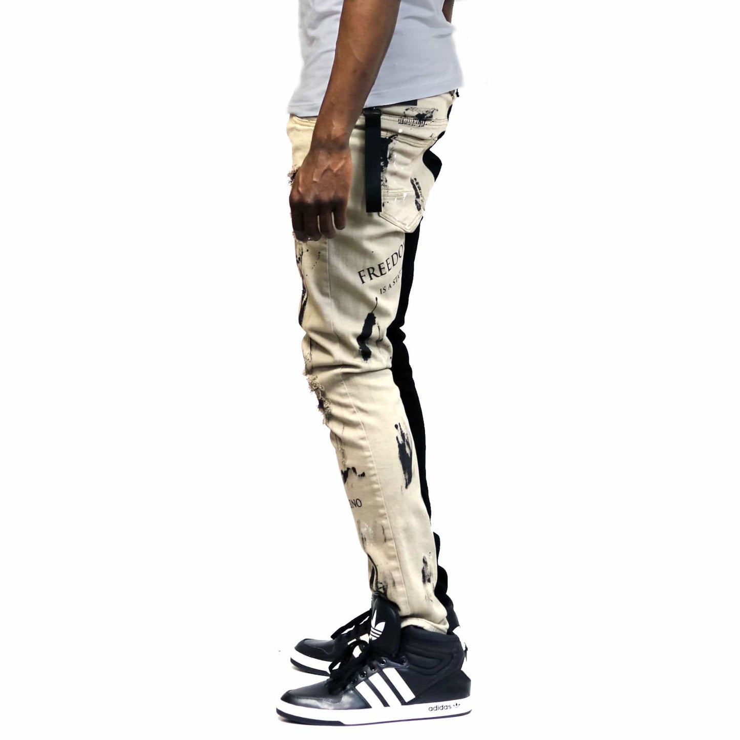 Side view of the black skinny twill pants featuring cargo pockets.