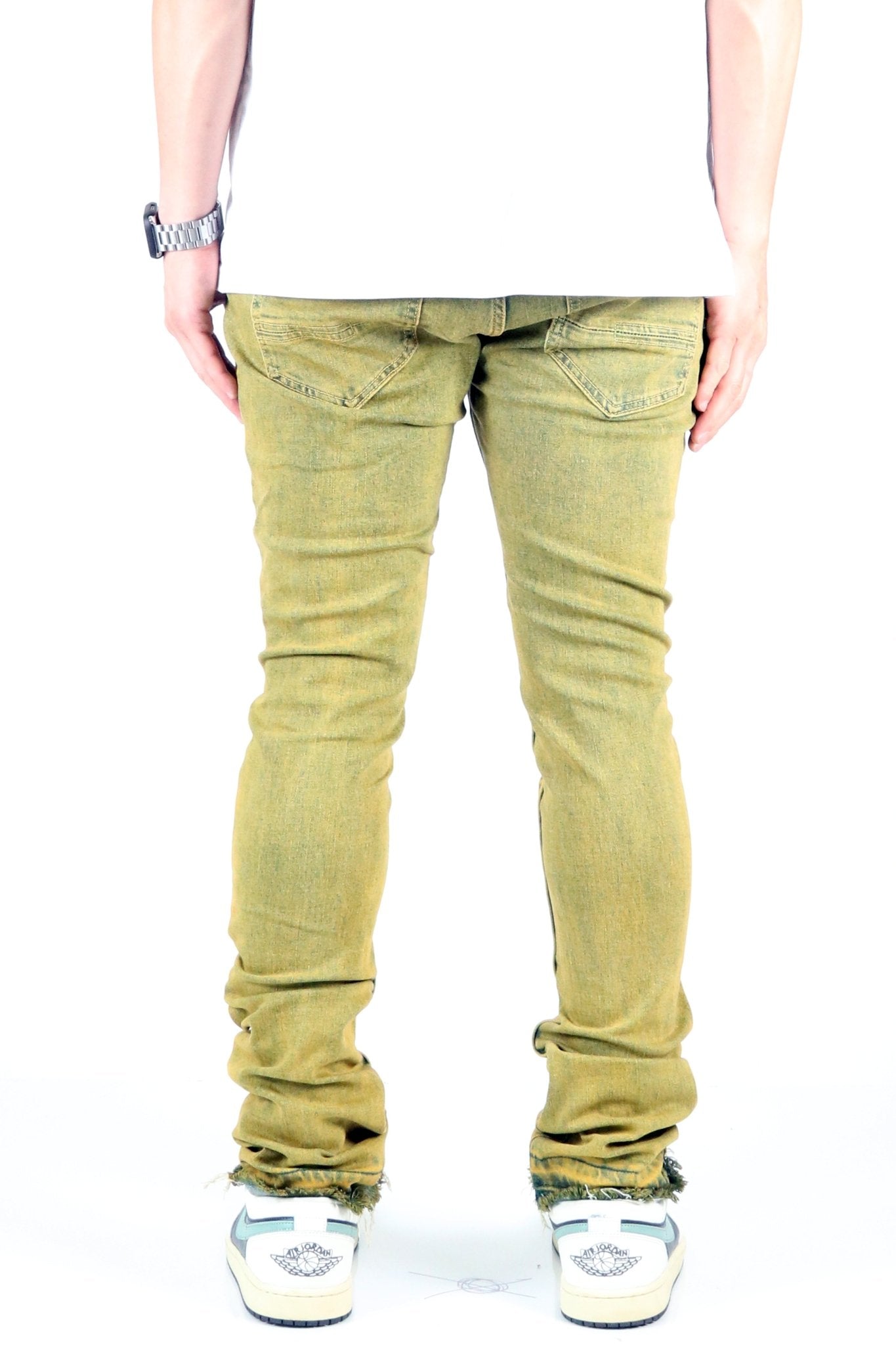 Back view of the vintage olive skinny denim pants focusing on the slim fit.