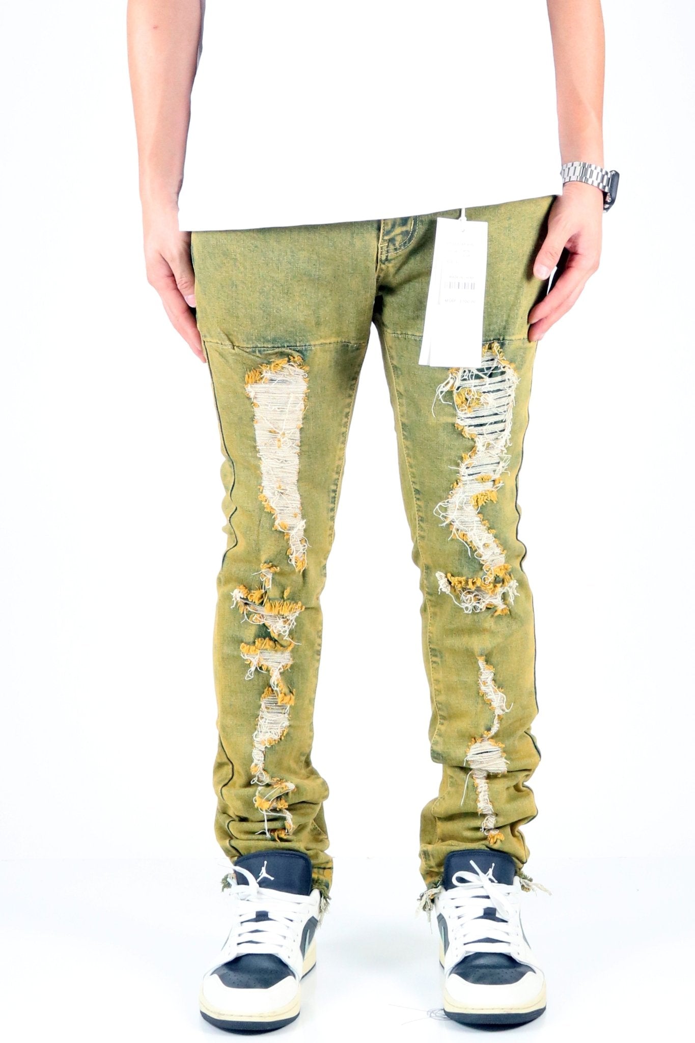 Front view of the vintage olive skinny denim pants with distressed details.
