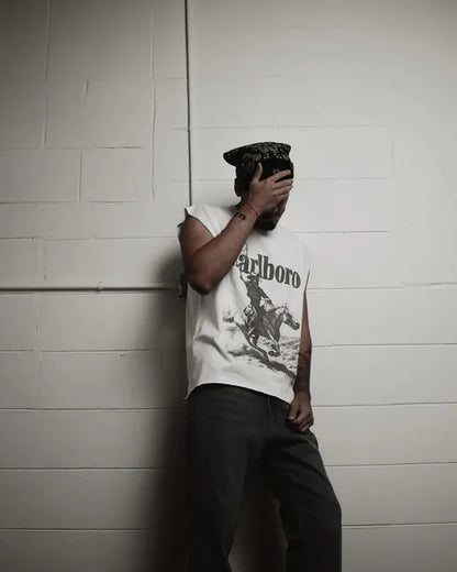 Lifestyle shot of a man in a sleeveless shirt with graphic print.