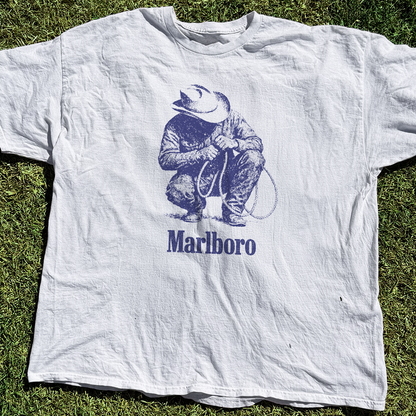 Detail close-up of the graphic print on the wrinkled white t-shirt.