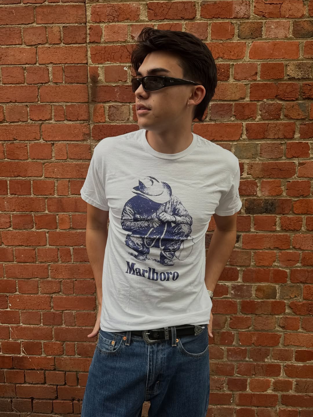 Lifestyle shot of a man in a graphic white t-shirt outdoors.