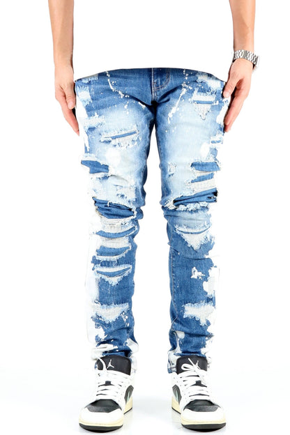 Front view of blue distressed skinny jeans with ripped details.