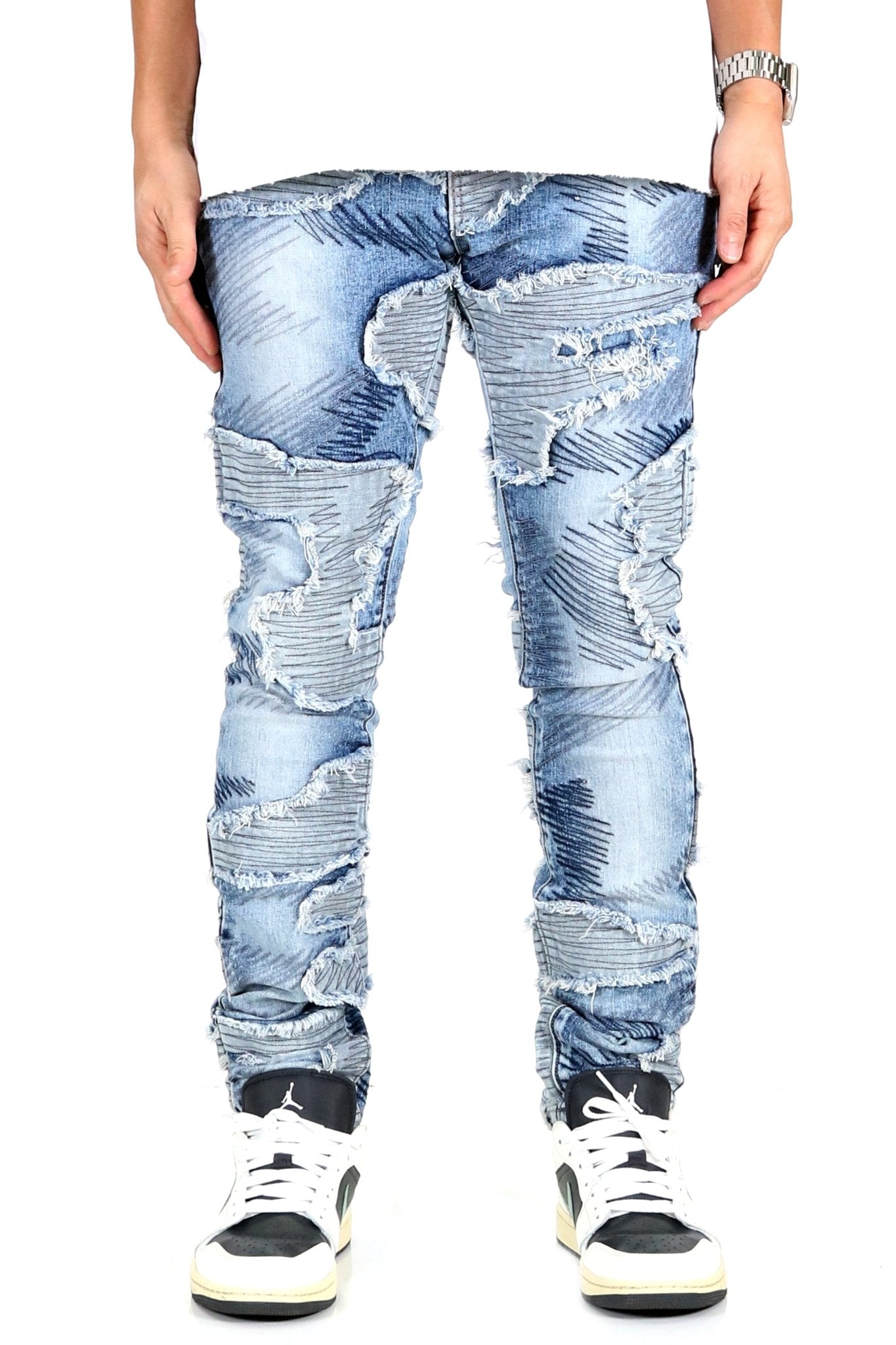 Front view of blue skinny denim pants with distressed design.