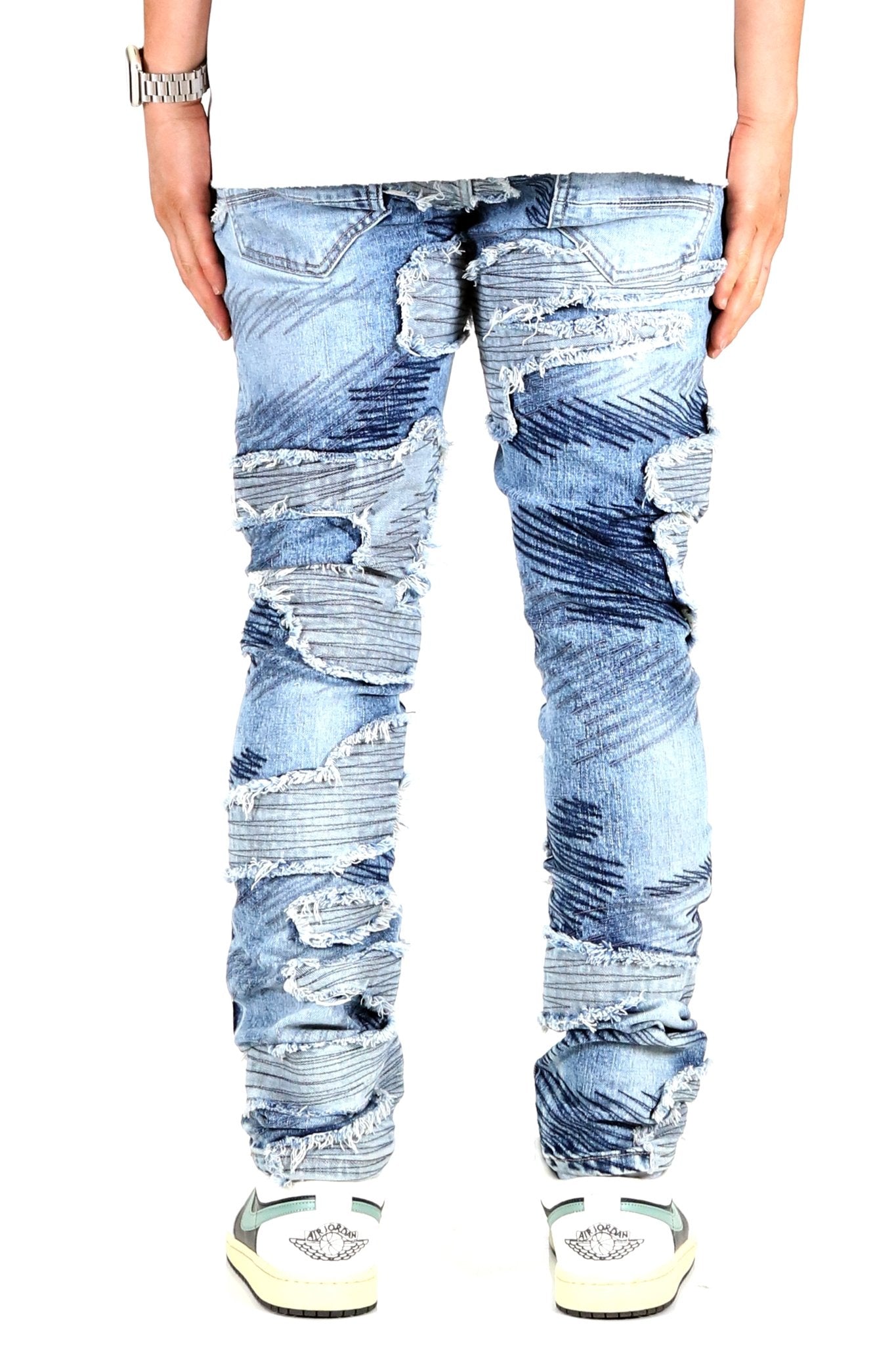 Front view of blue skinny denim pants with distressed design.