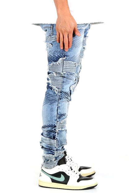 Side view of blue skinny denim pants showcasing hand placement.