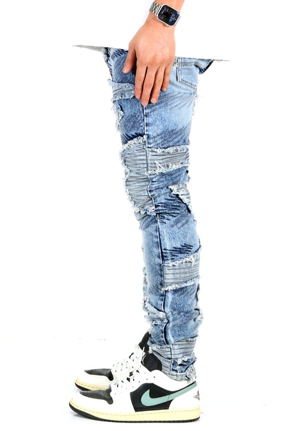 Side view of blue skinny denim pants showcasing hand placement.