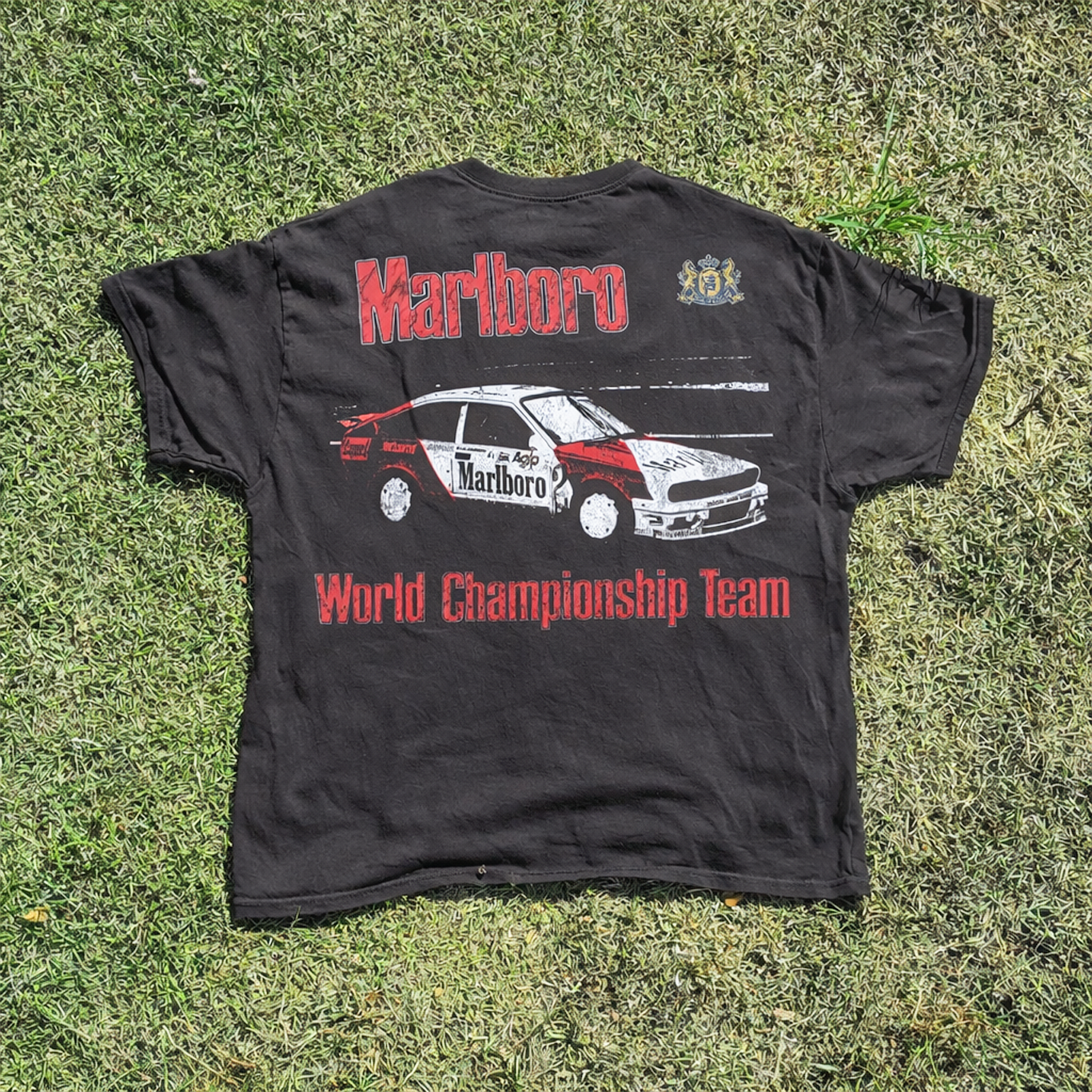 Back view of a black t-shirt featuring graphic design and text print.